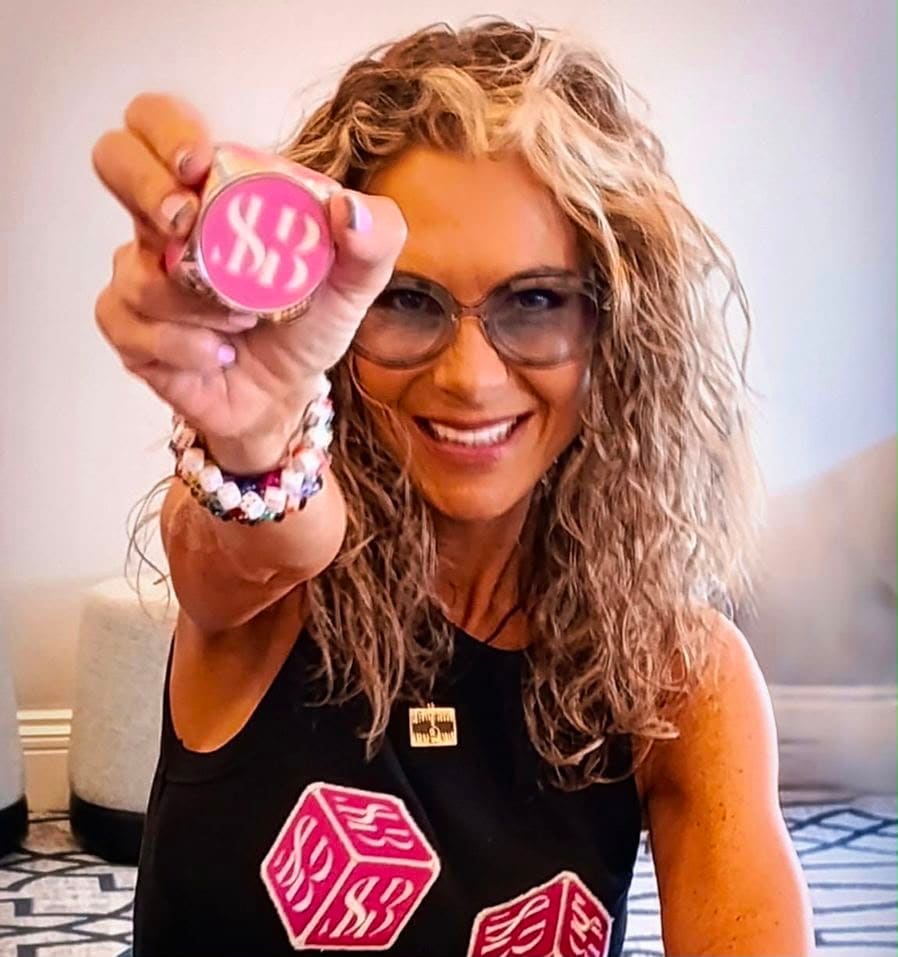 Stacey Barbaglia holding a pink SHB backgammon checker